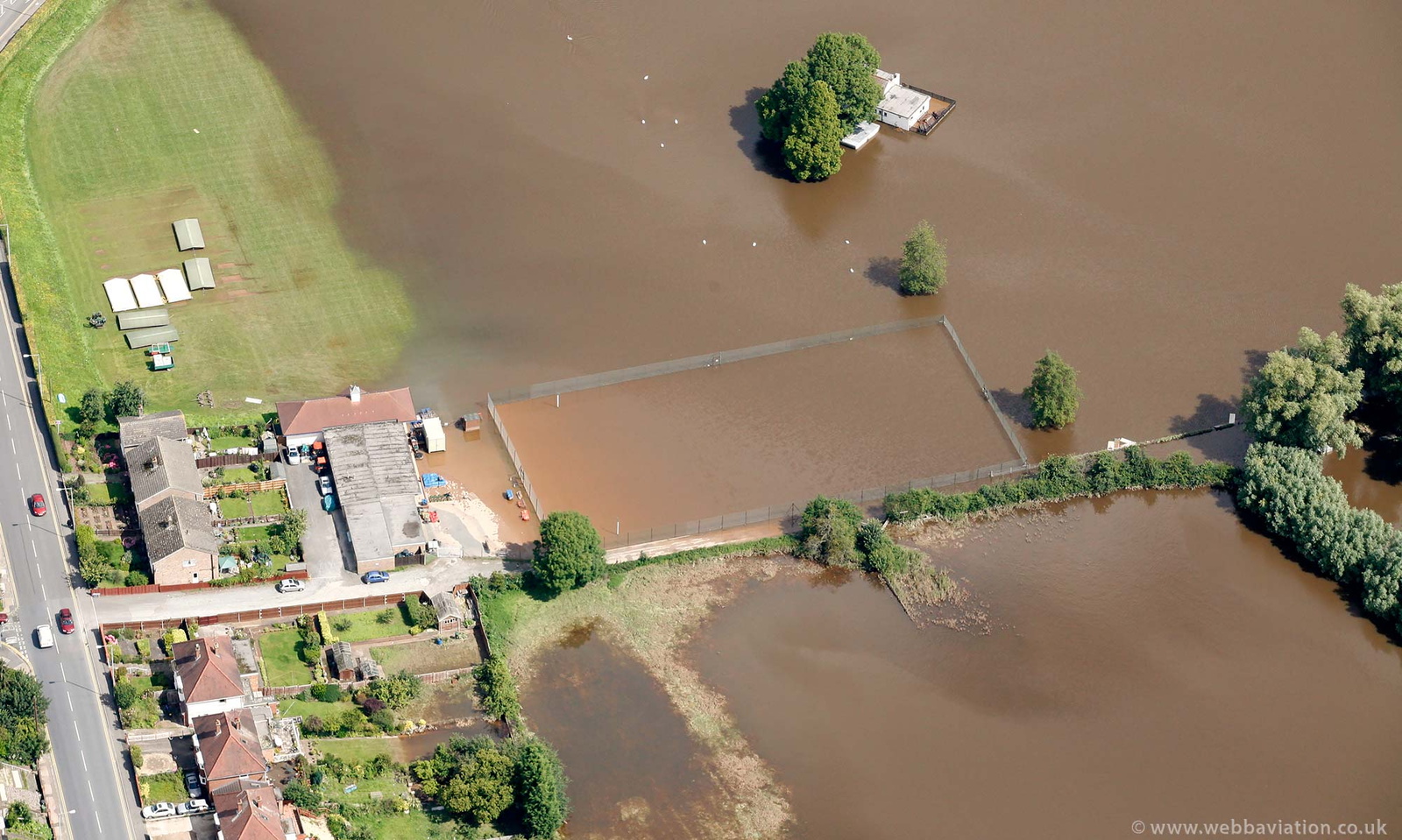 tennis court on  Slingpool Walk  during the great floods of 2007 from the air