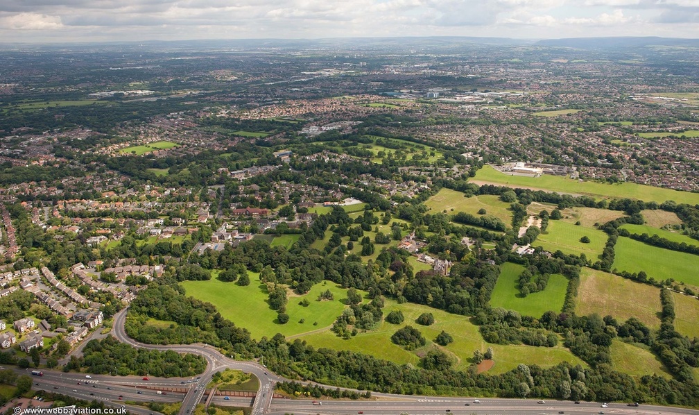 Cheadle with  Bruntwood Hall and Bruntwood Park in the foreground  from the air
