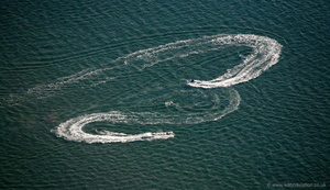  jet skis playing on a turquoise sea on the Llyn Peninsula Wales  from the air 