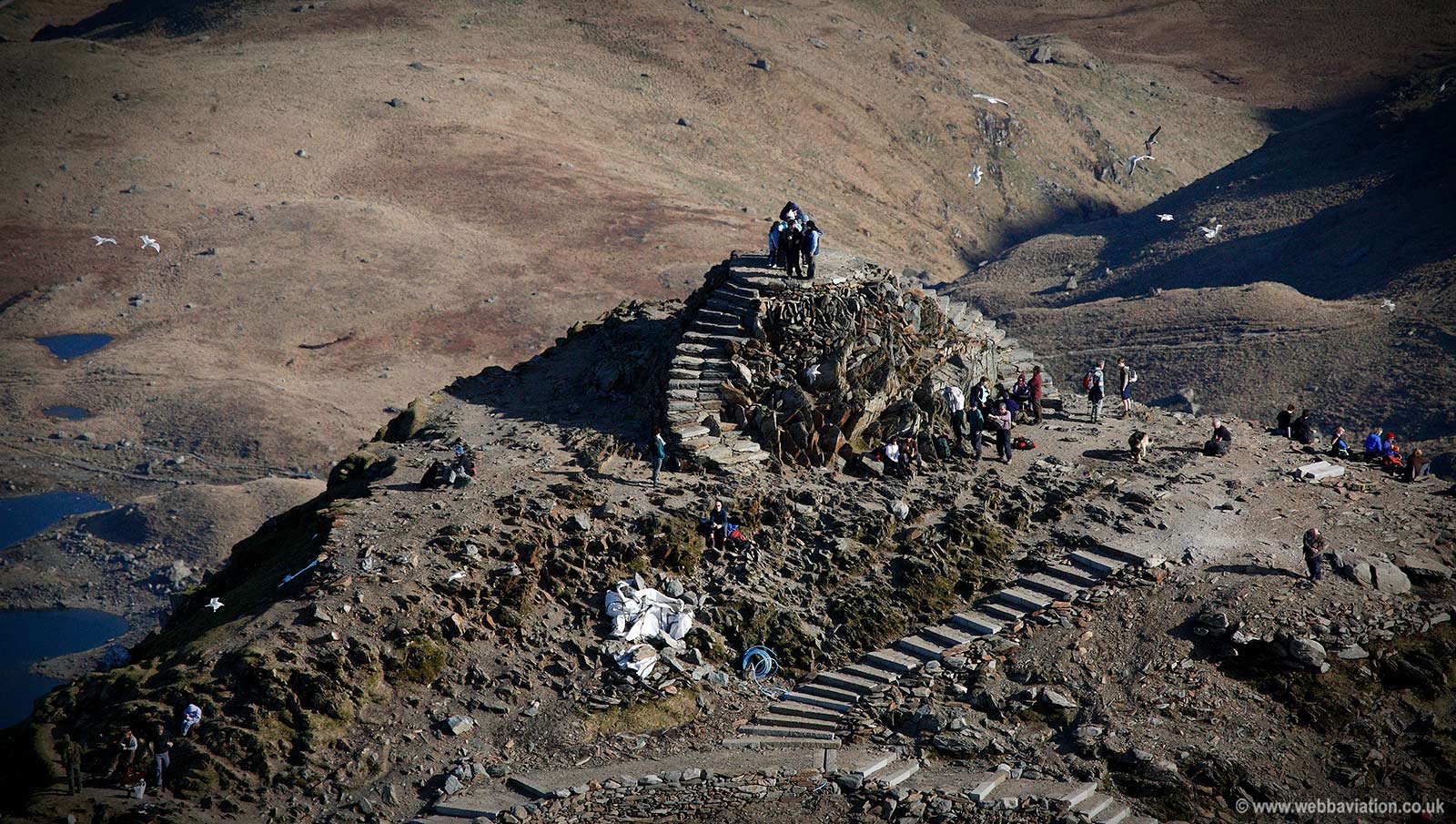 walkers on the summit of mount snowdon Snowdonia Wales